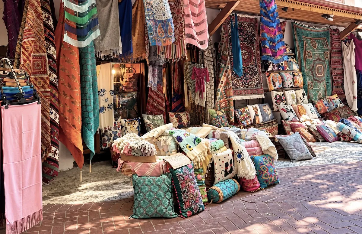Carpets, kilims, scarves and cushions displayed outside a shop in the old town of Fethiye